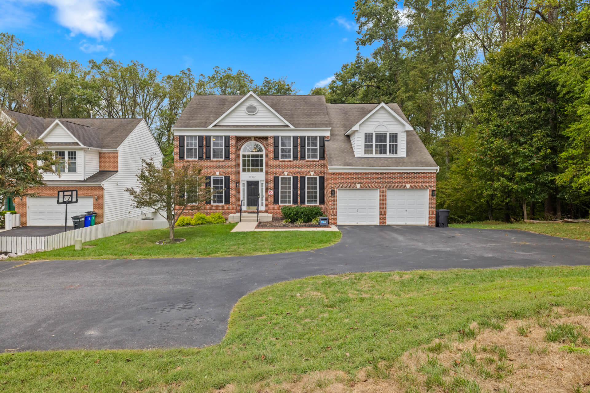 Full view of the home's front exterior and spacious driveway.