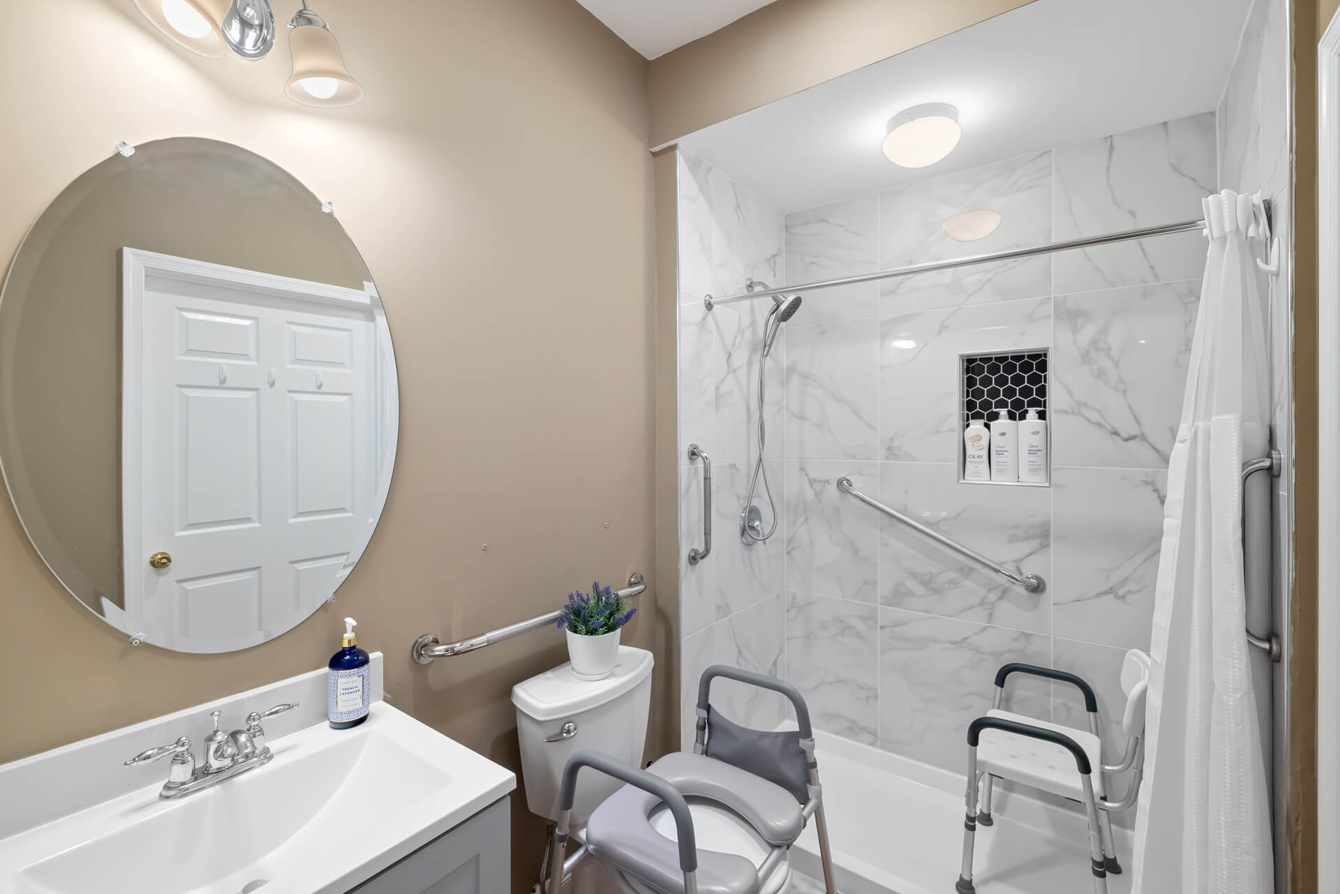 Accessible bathroom with roll-in shower and support rails
